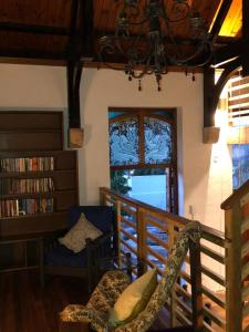 a living room with a chair and a window at La Chapelle - The Library in Montagu