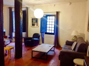a living room with a couch and a coffee table at Maison pittorresque St Paul de Vence in Saint Paul de Vence +31 photos