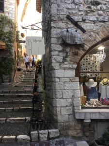 a group of people walking down a stone alley at Maison pittorresque St Paul de Vence in Saint Paul de Vence