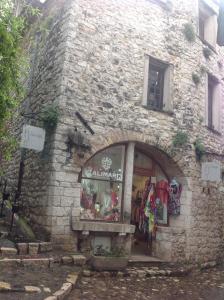 a store in a stone building with a window at Maison pittorresque St Paul de Vence in Saint Paul de Vence