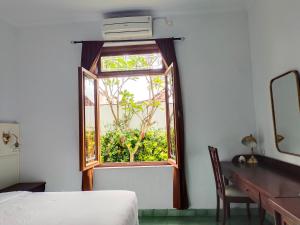 A bed or beds in a room at Griya Asih