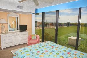 1 dormitorio con cama y ventana grande en Smuggler's Cove, en Atlantic Beach