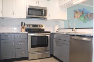 a kitchen with stainless steel appliances and a microwave at A Place At The Beach V in Atlantic Beach