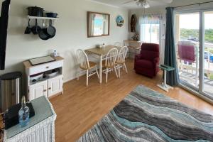 ein Wohnzimmer mit einer Küche sowie einem Tisch und Stühlen in der Unterkunft A Place At The Beach VI in Atlantic Beach