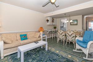 a living room with a couch and a table and chairs at Pine Knoll Townes in Pine Knoll Shores