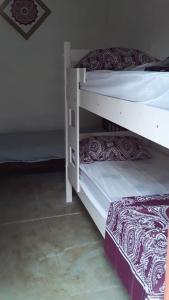a couple of bunk beds in a room at N1 2 Apto Pequeño Habitación con baño privado a 120 metros de Plaza Batlle punto Central de la Ciudad in Artigas