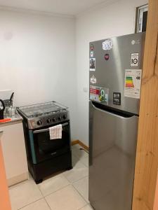 a kitchen with a stove and a refrigerator at Viña City Hostel II in Viña del Mar