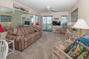 a living room with a couch and a tv at Seaspray II in Atlantic Beach