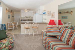 a living room with a couch and a kitchen at Seaspray II in Atlantic Beach
