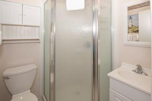 a bathroom with a shower and a toilet and a sink at Seaspray II in Atlantic Beach