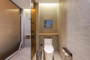 a bathroom with a white toilet and a shower at Atour Hotel Quzhou Nankong in Quzhou +39 photos