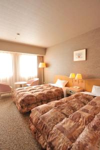 Postel nebo postele na pokoji v ubytování Rako Hananoi Hotel