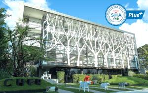 a building with some white animals in front of it at Cher Resort SHA Plus Certified in Cha Am