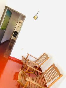 two rocking chairs in a room with a butterfly on the wall at Bole Guest Bentota in Bentota +104 photos