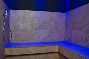 a bathroom with a shower with blue lighting at Hotel Peter in Petersberg