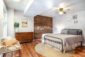a bedroom with a bed and a brick wall at Heart of the Old City- Minutes from Market Square in Knoxville