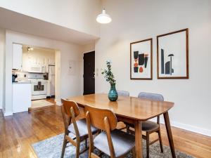 a kitchen and dining room with a wooden table and chairs at Spacious Old City Loft in Knoxville