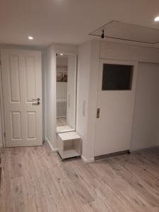 an empty room with a white door and a staircase at Haus Groth - Wohnung Heinke - Schupp1 in Tönning