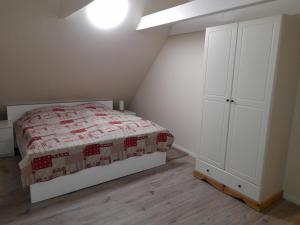 1 dormitorio con 1 cama y armario blanco en Haus Groth - Wohnung Heinke - Schupp1, en Tönning