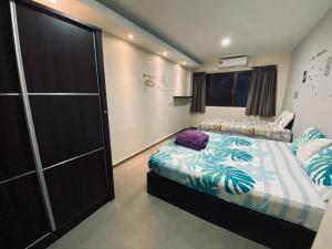 a bedroom with two beds and a closet at Budget for 12 in Ipoh