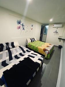 a room with two beds in a room at Budget for 12 in Ipoh