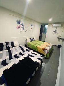 a room with two beds in a room at Budget for 12 in Ipoh +3 photos