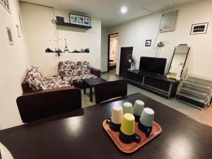 a living room with a table with candles on it at Budget for 12 in Ipoh