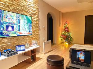 a living room with a christmas tree and a tv at Villa Vadian & Pool in Gevgelija
