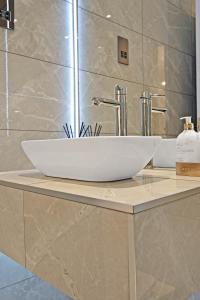 a white sink on a counter in a bathroom at Pitcorthie House in Dunfermline +34 photos