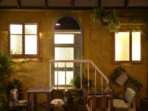 a room with three windows and a stair case at DG Hotel in Taipei