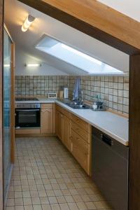 a kitchen with a sink and a stove at Sonnig, Balkon, Berge & im Herzen von Sonthofen in Sonthofen