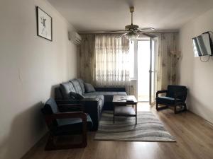 a living room with a couch and a table at Clean apartment on Lunacharskogo street in Tiraspol