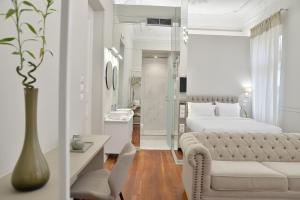 a white bedroom with a bed and a couch at 1900 ATHENIAN HOUSE in Athens +43 photos