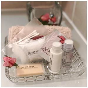 a basket with cosmetics and flowers on a counter at Rondeletia Cottage Guesthouse - premium self catering in Winston Park