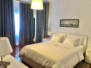 a hotel room with two beds and a lamp at HOTEL BOUTIQUE a ESPLANADA in Castelo Branco