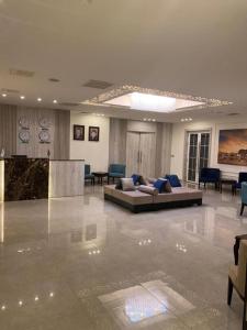 a large living room with a couch and tables in it at Jordan View Hotel in Amman