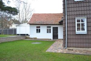 a white house with a brown roof at Ferienwohnungen im alten Pfarrhaus in Eisenach