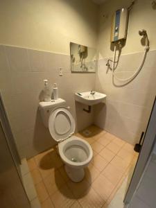 a bathroom with a toilet and a sink at YY Residences in Ipoh
