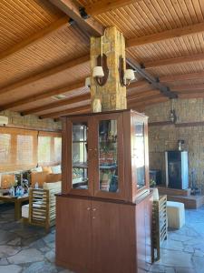 a large room with a wooden ceiling with a large cabinet at Villa Alexandra in Grevena