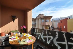 a balcony with a table and a view of a city at RNET - Apartments Roses Centre in Roses