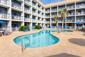 a swimming pool in front of a hotel at Travelodge by Wyndham Outer Banks/Kill Devil Hills in Kill Devil Hills
