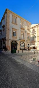 a large building on a street in a city at Ortigia Casa Fab in Syracuse