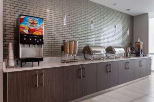 a kitchen with a counter top with a counter top at La Quinta Inn & Suites by Wyndham Shorewood in Shorewood