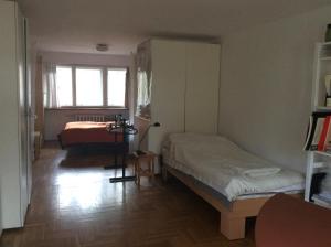 a bedroom with two beds and a window at Pokój w domu z ogrodem w Milanówku in Milanówek