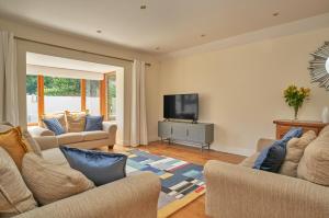 a living room with two couches and a flat screen tv at Dublin 'Home from Home', Luxury, Private Secure House in Dublin