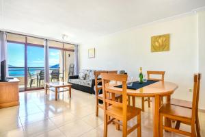 a living room with a table and a couch at Homeincalpe Rosamarina 9C in Calpe