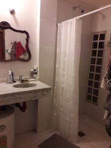a bathroom with a shower curtain and a sink at Departamento Yokavil in Santa María