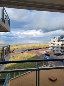 a view from the balcony of a condo overlooking the ocean at Zeesterflat 117 in Egmond aan Zee