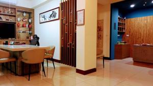 Camera con tavolo, sedie e TV di Plum Green Homestay a Jinning