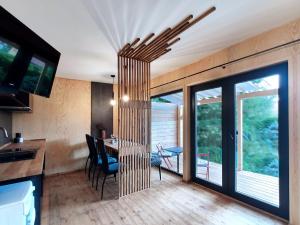 a kitchen and dining room with a table and chairs at Chata NEMO in Hlinsko